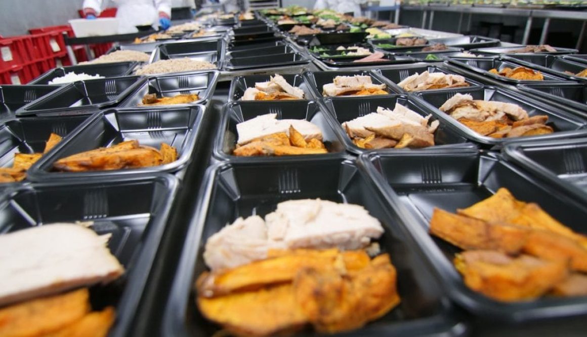 a bunch of trays filled with different types of food